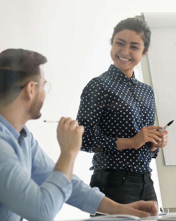 teammates working at whiteboard